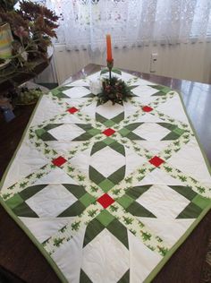 a quilted table topper on a dining room table