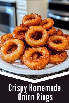 crispy homemade onion rings on a white plate with the words crispy homemade onion rings