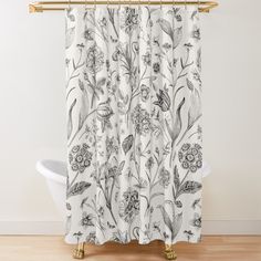 a white shower curtain with black and white flowers on it