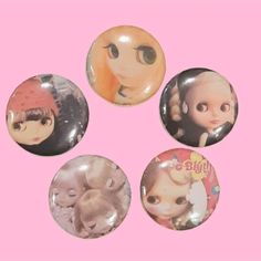 four buttons with pictures of dolls on them