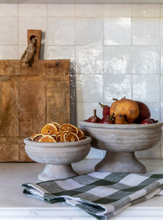 two bowls filled with fruit sitting on top of a counter