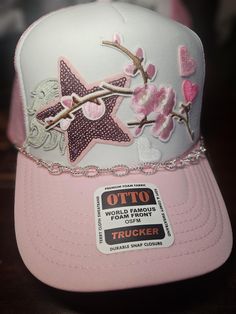 This adorable decked out hat features an assortment of embroidery patches as well as a silver detachable chain.  This is the perfect accessory for any look. Hat With Patches, Custom Made Hats, Manchester Nh, Custom Decks, Embroidery Patches, Baseball Caps, Terry Cloth, Trucker Cap, Halloween Shopping