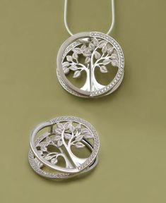 You’ll do a double take with this pendant’s exquisite architecture. Its multiple layers create stunning depth and dimension while crystal inlays round out the piece with a sparkling border. Look at it head on and the tree appears to pop! The Tree of Life represents harmony and interconnectedness: its border shows we are all linked together in the great circle of life. Made of sterling silver, this pendant measures 1 inch wide and 1 inch long. Tree of Life sparkling pendant Unique three-dimension Elegant Tree Of Life Jewelry For Anniversary, Tree Of Life Round Pendant Jewelry For Anniversary, Unique Tree Of Life Round Pendant Jewelry, Unique Tree Of Life Round Jewelry, Elegant White Gold Tree Of Life Jewelry, Tree Of Life Round Jewelry For Anniversary, Nature-inspired Tree Of Life Round Jewelry, Transformable Jewellery, Silver Earrings Outfit