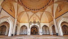 the inside of an ornate building with columns and arches