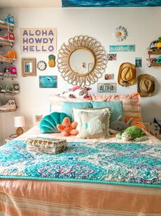 a bed with colorful pillows and pictures on the wall above it, along with other items