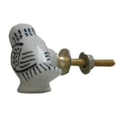 a close up of a knob with a bird on it's face and a screw in the middle