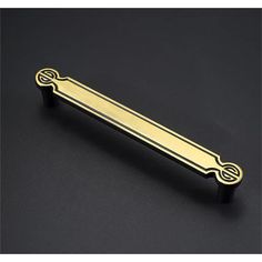 an image of a brass door handle on a black surface with the word's name in