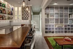 a kitchen with lots of counter space and shelves on the wall, along with a bar