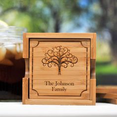 the personalized wooden coaster is next to a jar of iced tea on a table