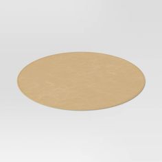 a round wooden table top on a plain white background with no people in the photo