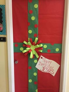 the door is decorated with green and red polka dot paper, tied with a bow