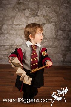 a young boy dressed in a harry potter costume