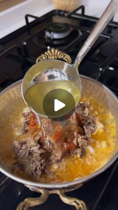 a pan filled with food sitting on top of a stove next to a burner