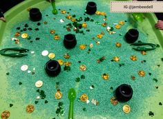 a green tray filled with lots of gold and black items on top of it's surface