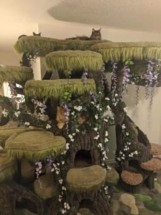 a cat house made out of moss and flowers