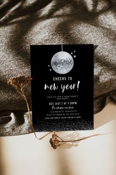 a black and white new year's party card with a disco ball on it