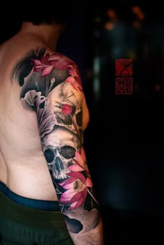 a man's arm with flowers on it