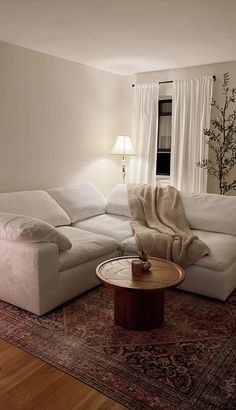 a living room with a white couch and coffee table