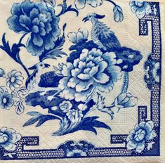 a blue and white plate with flowers, birds and butterflies on it's border