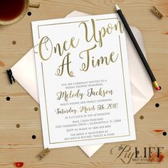 a white and gold wedding card with the words, one upon at time on it