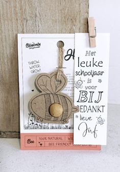 a card with a wooden ornament hanging from it's front and back