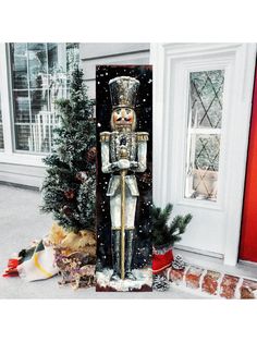 a christmas scene with a nutcracker in front of a house