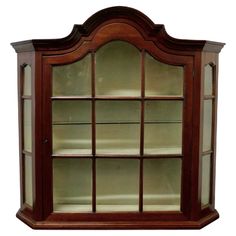 a wooden display case with glass doors on the top and bottom shelves in different sizes