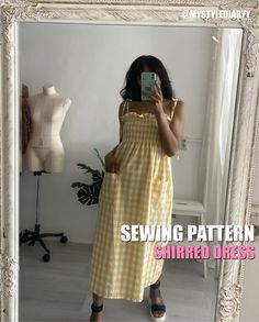 a woman taking a selfie in front of a mirror wearing a yellow and white gingham dress