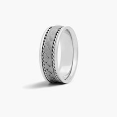 a white gold wedding band with braiding inlays on the inside of it