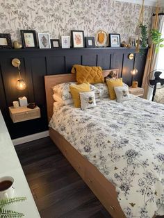 a bedroom with a large bed and pictures on the wall above it's headboard