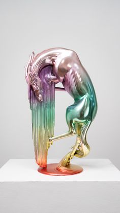 a colorful sculpture on top of a white surface