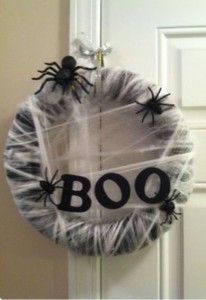 a halloween wreath with spider webs and boo on it