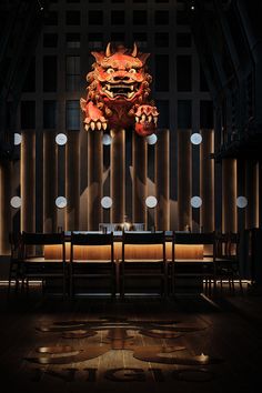 a table and chairs in front of a wall with lights