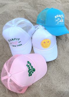 Starfit trucker hats! Offered in 4 styles. Mesh back with adjustable snapback. Terry fabric lines the inside for ultra comfort and sweat wicking. Smiley: white hat with chenille embroidery New York: light pink hat with 3D embroidery Varsity: white hat with embroidery Tropics: teal blue hat with print Pink Trucker Hat Aesthetic, Cute Hats For Summer, Cute Hats Summer, Trucker Hat Trendy, Pink Trucker Hats, Cute Summer Hats For Women, Girls Trucker Hats, Custom Trucker Hats Design, Beachy Trucker Hats