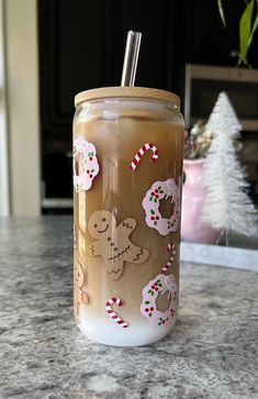 a glass jar filled with liquid sitting on top of a counter next to a christmas tree