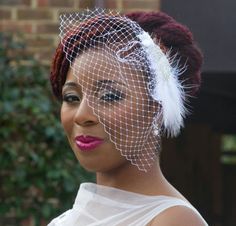 a woman wearing a birdcage veil on her head