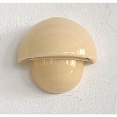 a beige door handle on a white wall