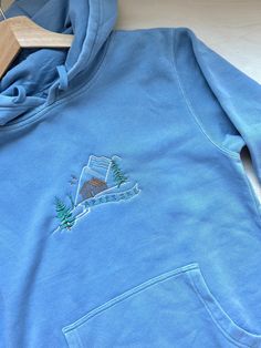 We sell primarily on our website where we offer faster turnaround and free shipping options. TwinRavenCo Embroidered Après Ski Mountain Scene. Material is Pigment Dyed giving a perfect Vintage Wash look.  These hoodies have a special split stitch double needle sewing on all seams and a twill neck tape. Made with 80% cotton and 20% polyester, these hoodies are super soft and cozy. Unisex, and have a perfect over-sized fit.  * Check out our socials for discounts, new releases, and to see how we run our shop: TwinRavenCo Embroidery stabilizer is applied to the back of every embroidered item and is never to be removed. It is there to keep the stitches stable over time. This stabilizer naturally softens with wear and after first wash. THIS DESIGN IS CUSTOM MADE BY TWINRAVENCO AND IS THE PROPERT Ski Hoodie Design, Winter Hoodie With Custom Embroidery In Relaxed Fit, Casual Hoodie With Custom Embroidery In Relaxed Fit, Ski Embroidery, Embroidery Hoodies, Minimalist Mountain, Split Stitch, Ski Mountain, Embroidery Hoodie