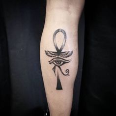 an egyptian tattoo on the leg of a person with an eye and an all seeing symbol