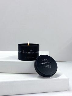 a candle that is sitting on top of a white box with the words, no character except