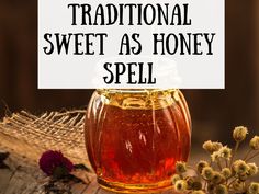 a jar of honey sitting on top of a wooden table next to flowers and a sign that says traditional sweet as honey spell