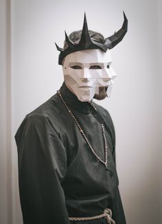 a man wearing a mask with horns on his head