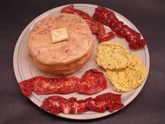 a white plate topped with different types of food on top of a black tablecloth