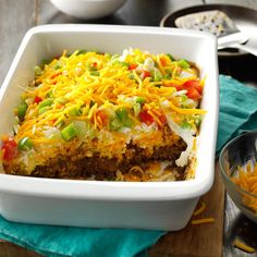 a casserole dish with shredded cheese and vegetables