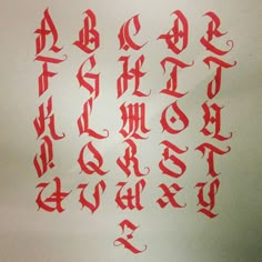 an old english type of calligraphy written in red ink