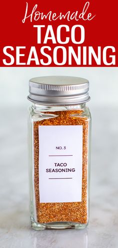 a glass jar filled with taco seasoning on top of a counter