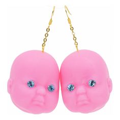 two pink heads with blue eyes hanging from chains