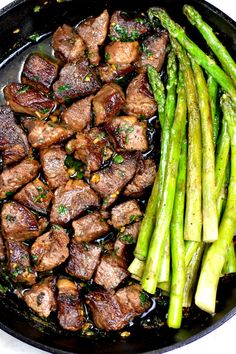 steak and asparagus in a skillet