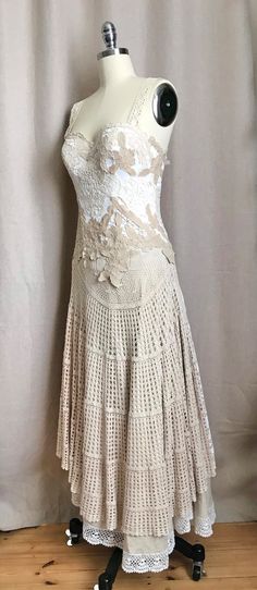 a mannequin wearing a white dress with flowers on it