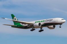 an eva air cargo plane flying in the sky with its landing gear down and it's landing gear down